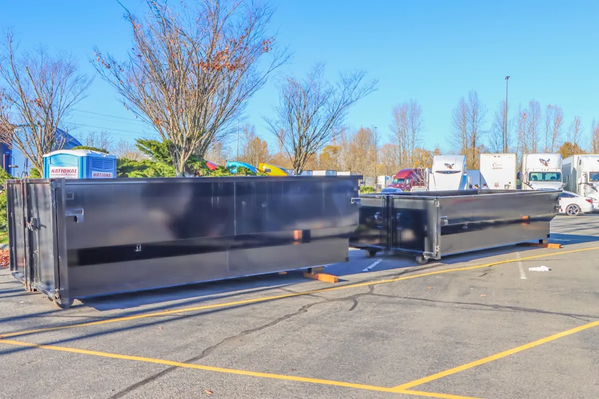 Professional dumpster rental service with roll-off container on residential driveway in Kensington